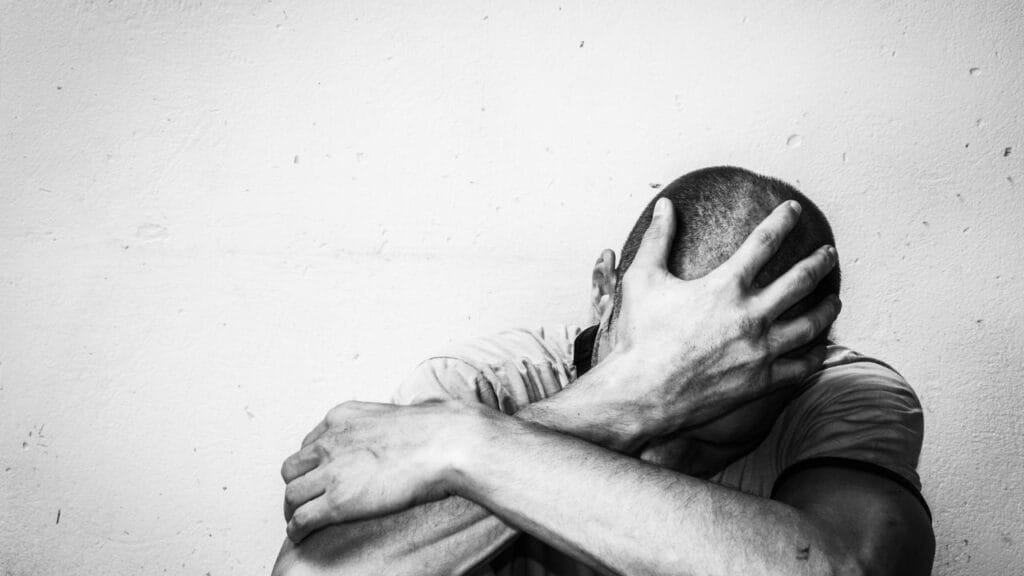 Man with Depression holding his hand on his head