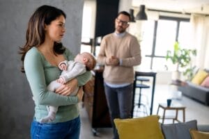 mother looking thoughtful about ketamine for postpartum depression relief